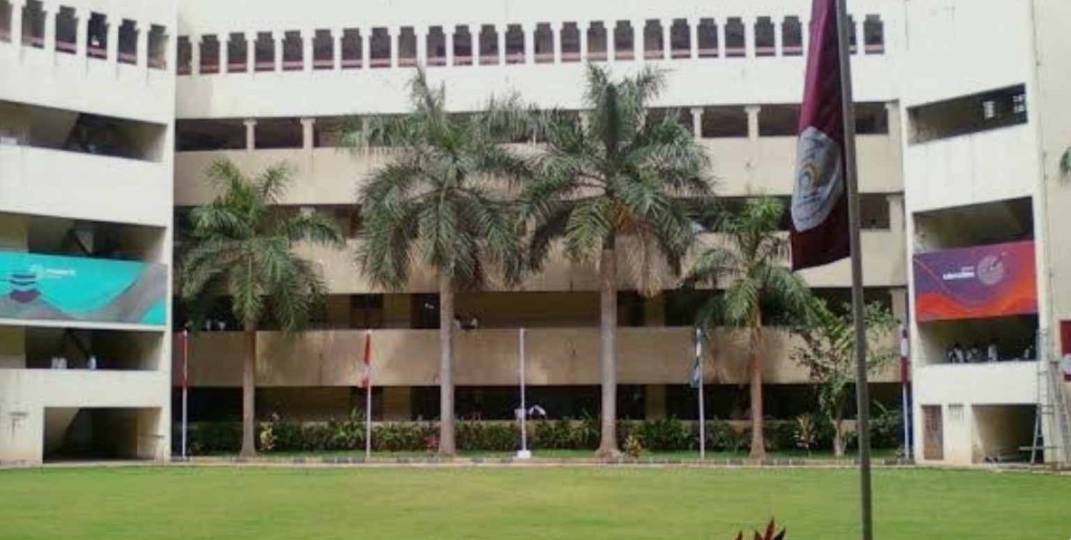BVIT’s white campus building, palm trees and lawn